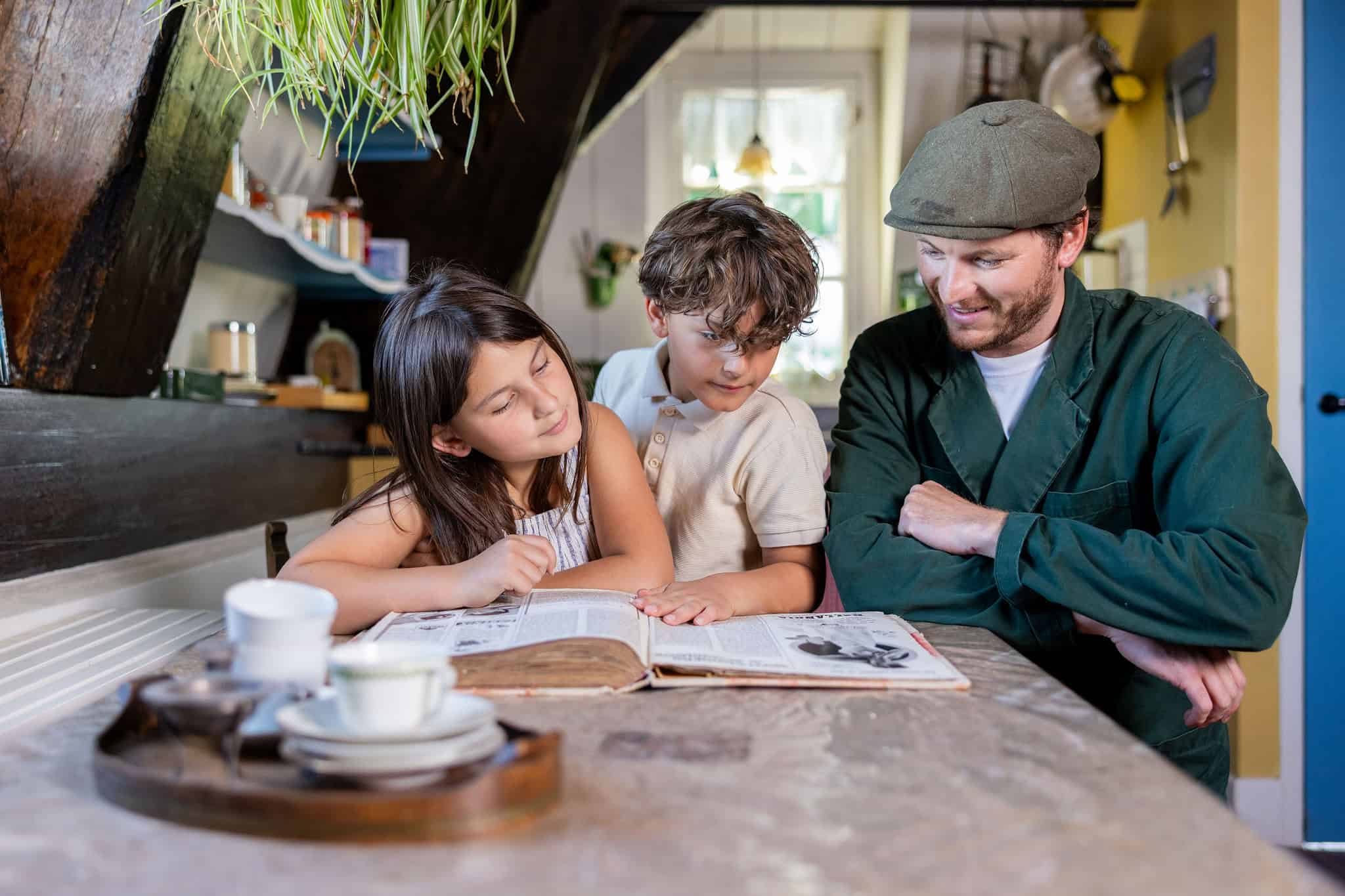 Kids inside the windmill reading with the miller